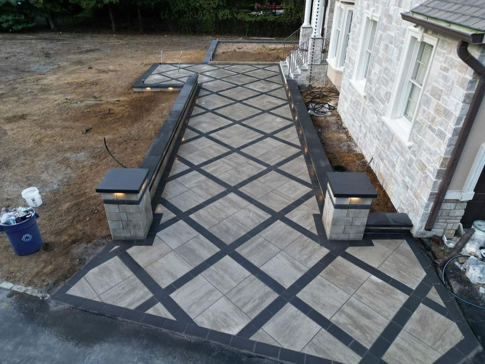 Elegant stone walkway with geometric pattern and lighting features, enhancing outdoor aesthetics.